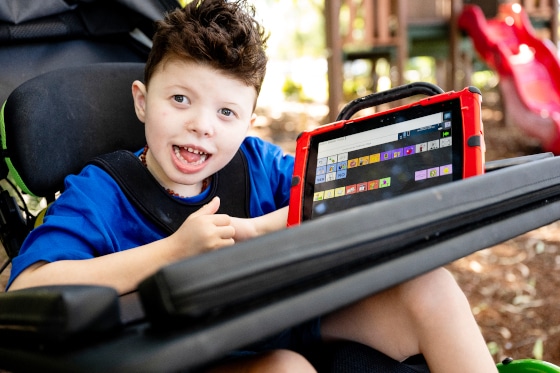 Child with Liberator AAC device
